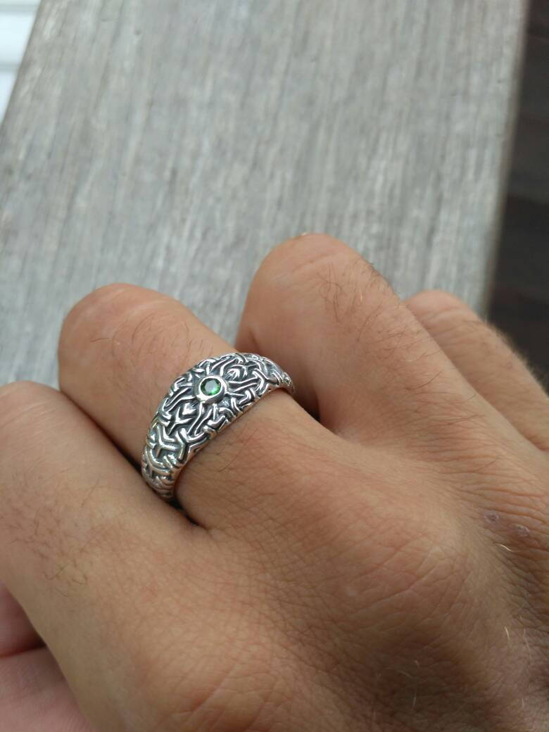 Silver sacred geometry ring photographed on hand