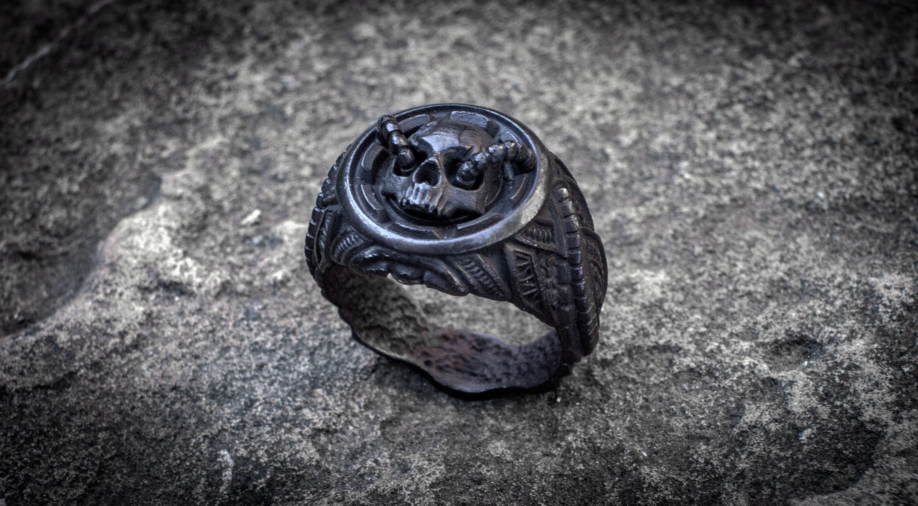 Biomechanical silver skull ring with polished highlights