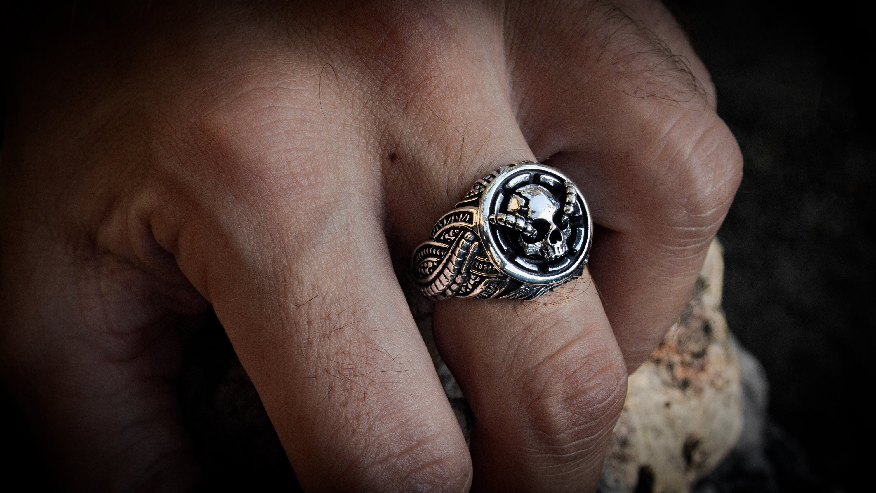 Silver skull ring displayed from alternate side angle