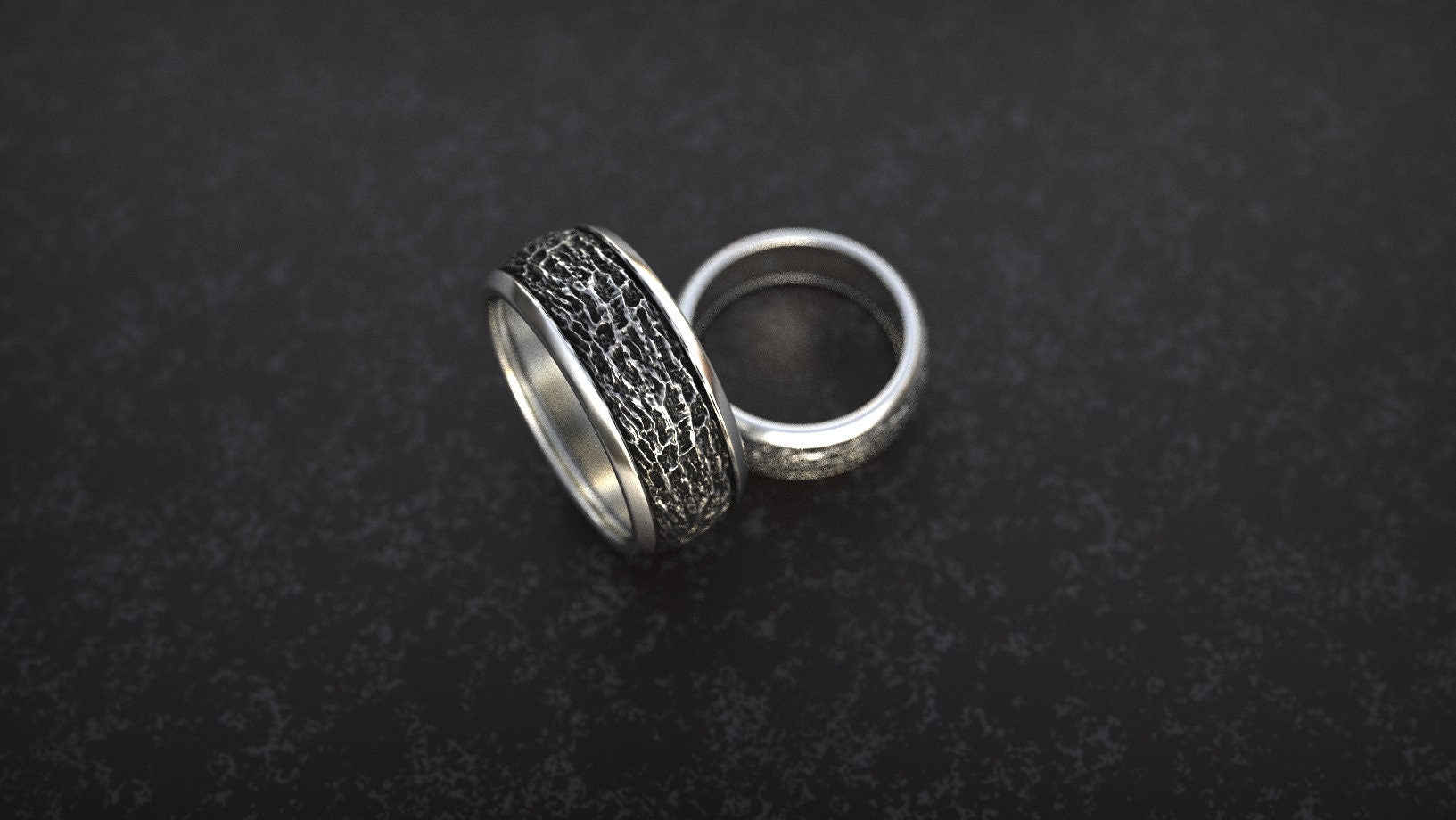 Textured gold jewelry displayed on dark background