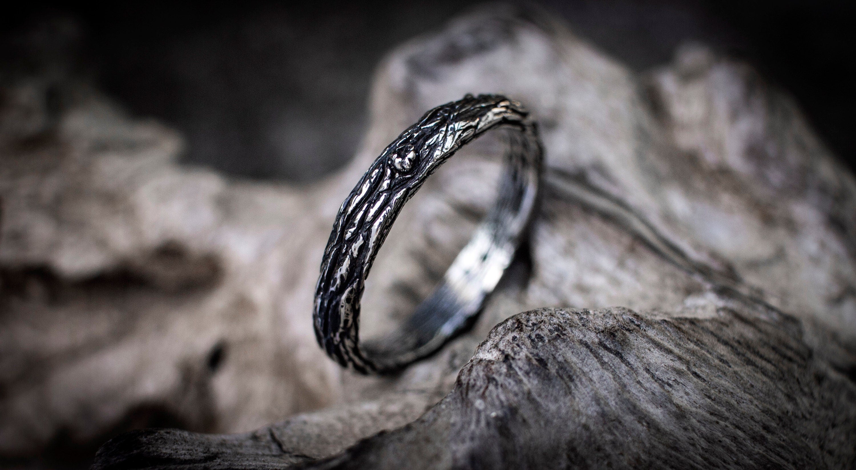 Textured silver tree bark ring set displayed vertically