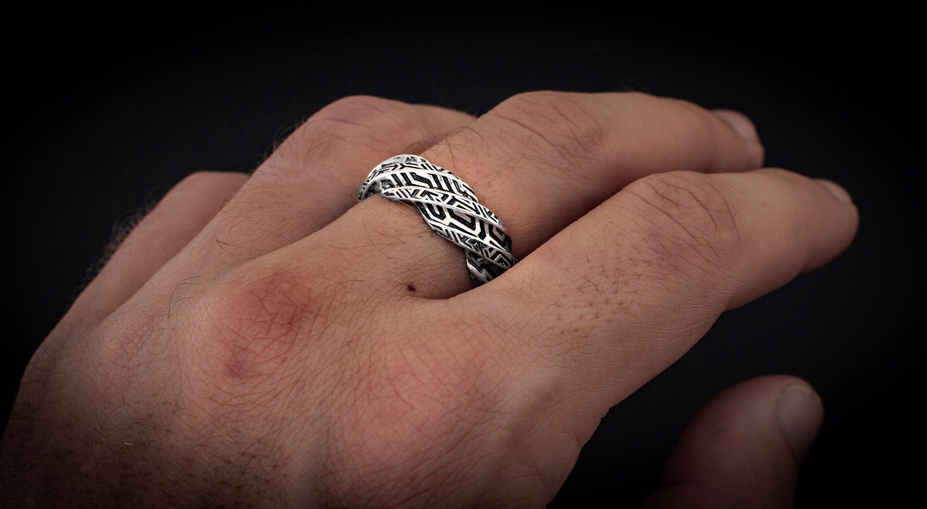 Handmade twisted silver jewelry shown from angled profile