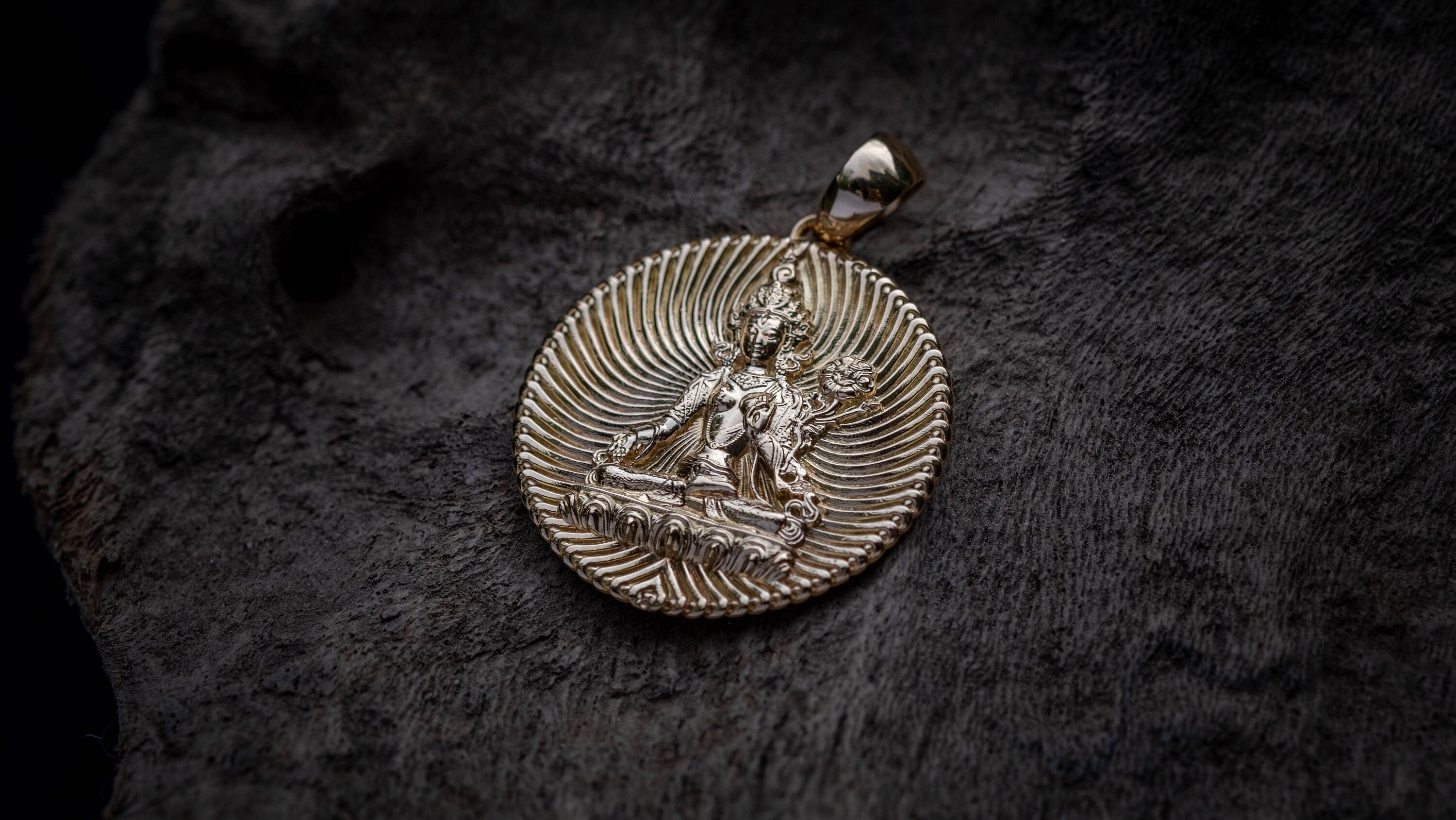 Side view of handmade gold Buddhist goddess pendant