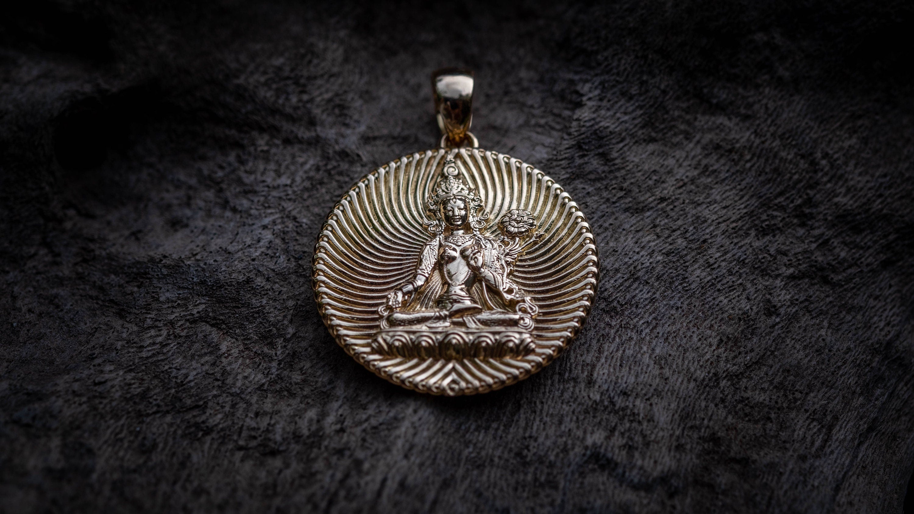 Gold Tara pendant photographed as spiritual jewelry
