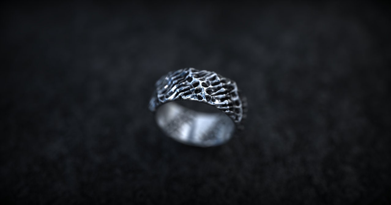 Dark textured silver ring photographed from front angle