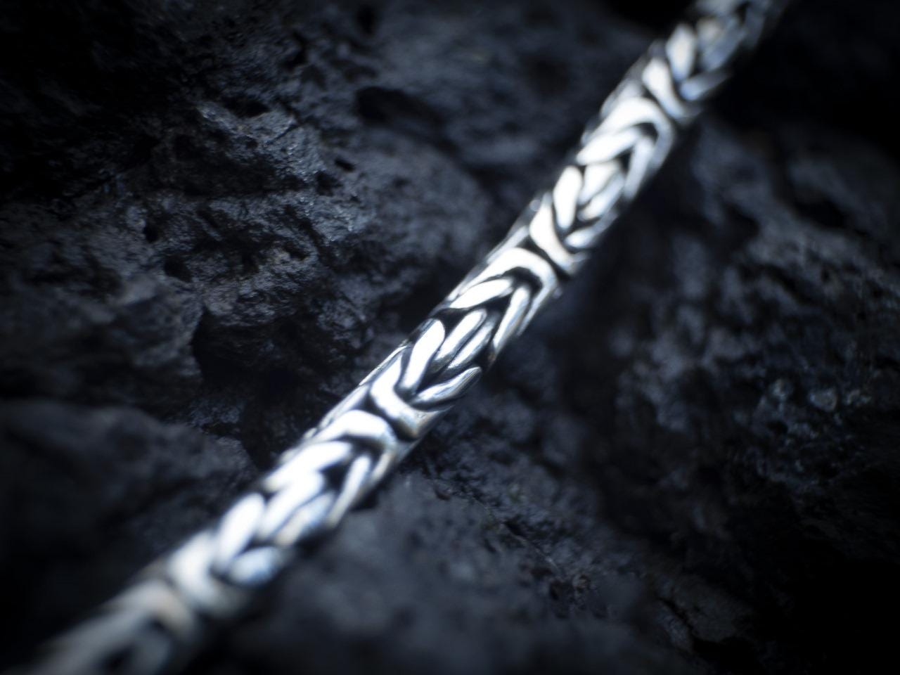 Vertical view of silver lion head pendant