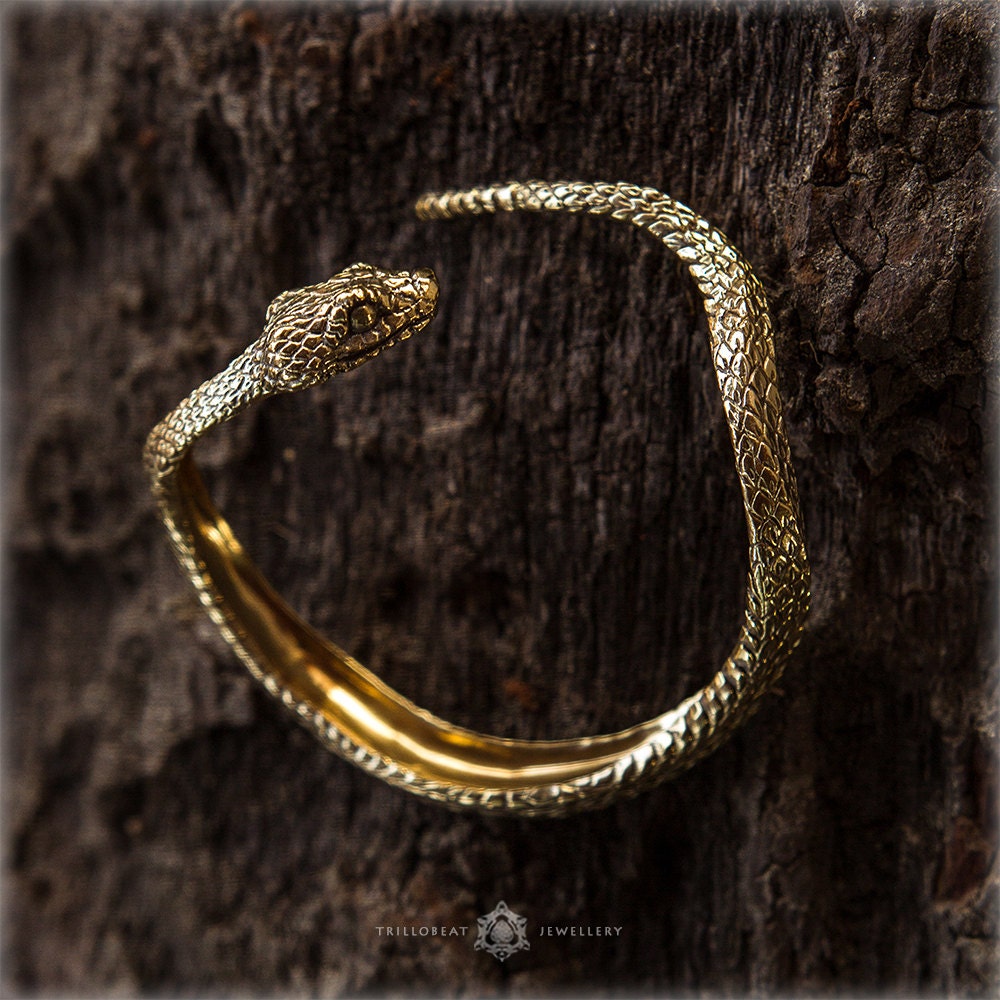 Handmade snake cuff displayed on dark background