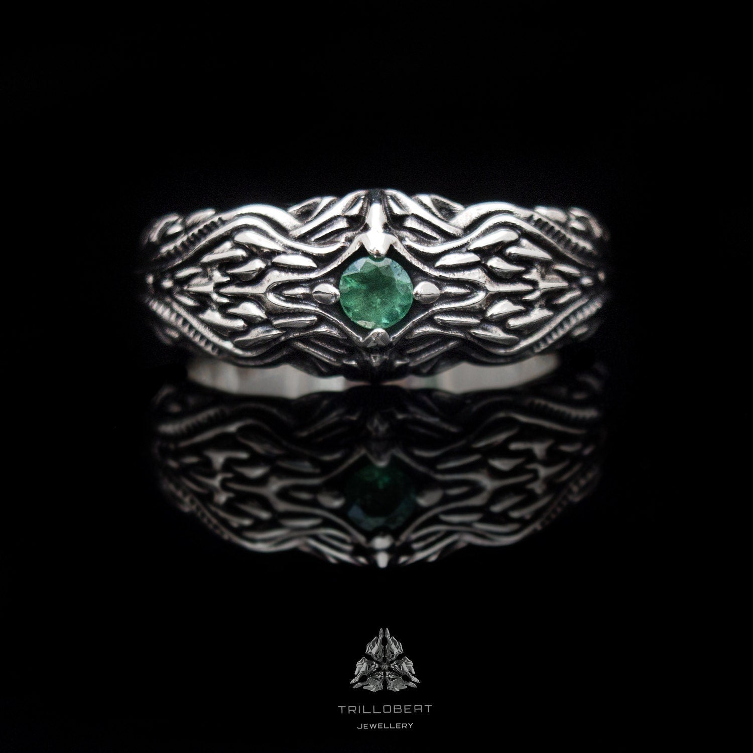 Silver dragon scale ring photographed from front angle