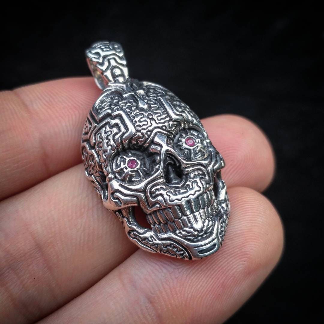 Silver skull pendant photographed as statement necklace