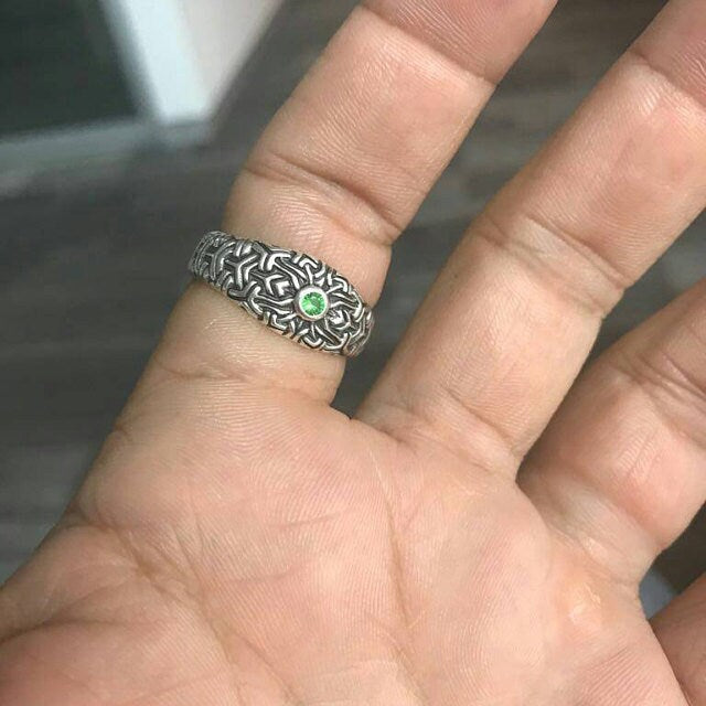 Handmade silver mandala jewelry displayed on dark background