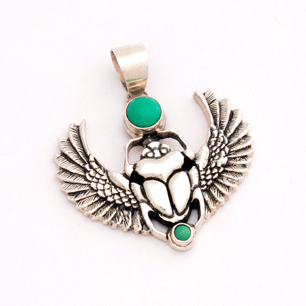 Sterling silver scarab pendant displayed on dark background