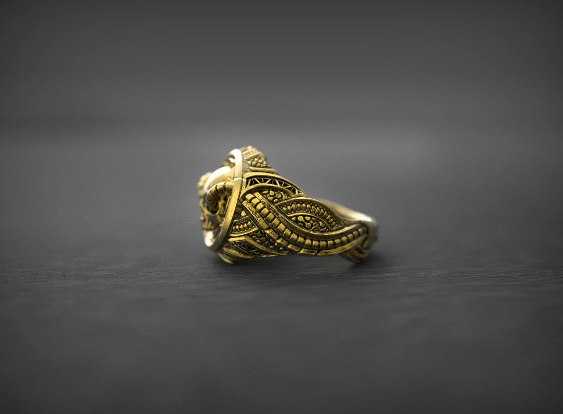 Gold skull ring shown from angled side profile
