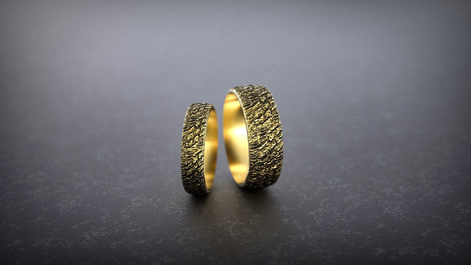 Side view of yellow gold textured wedding band set