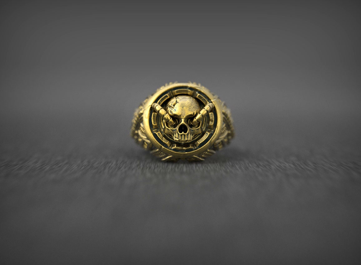 Gold skull ring photographed from front angle