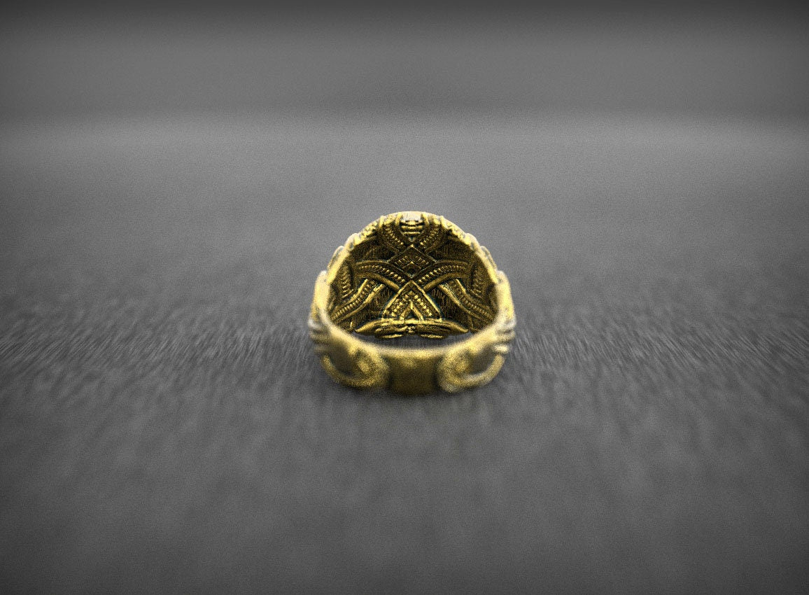 Gold Biomech Skull ring displayed on dark background