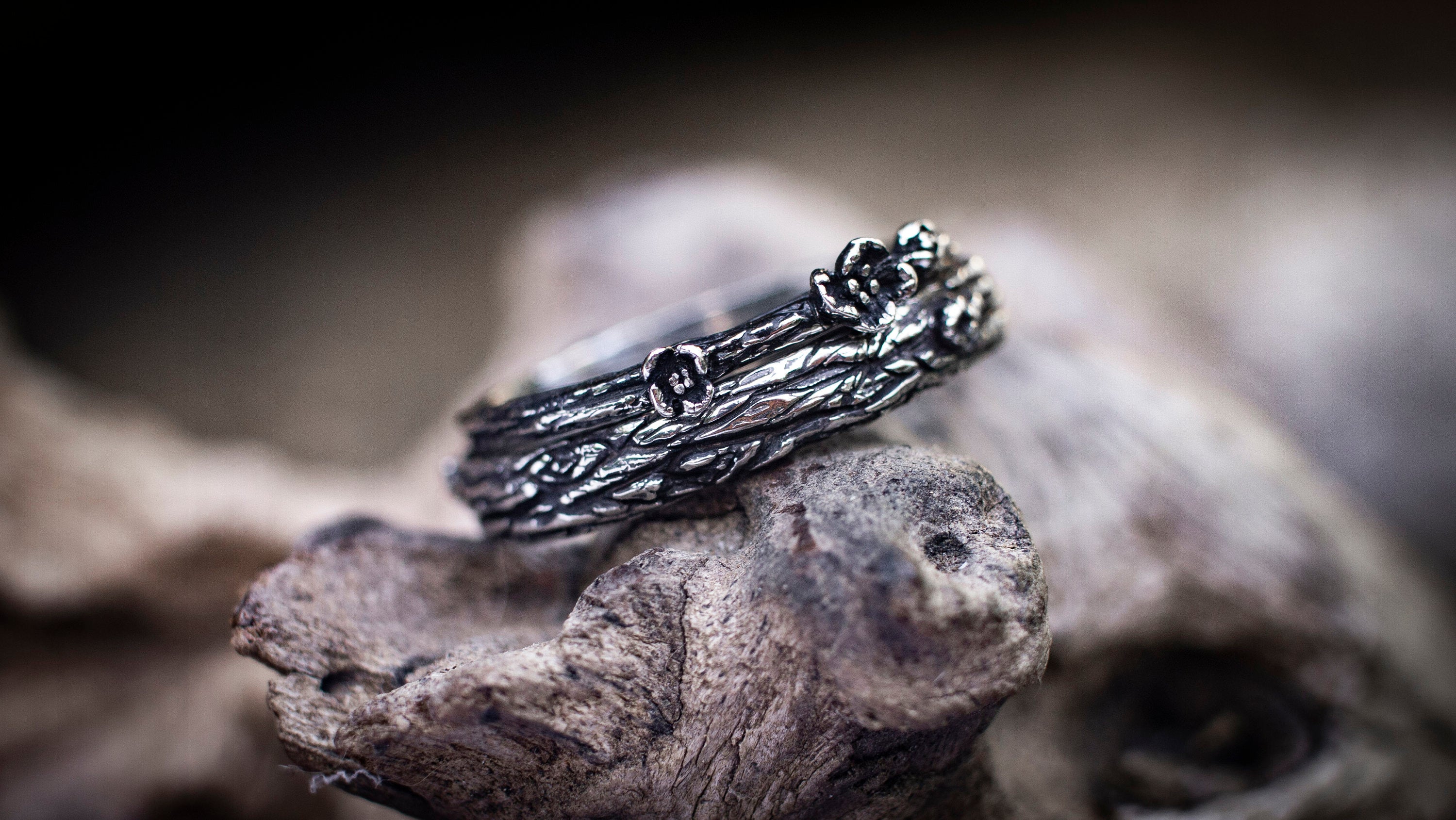 Silver tree bark bands displayed as organic wedding rings