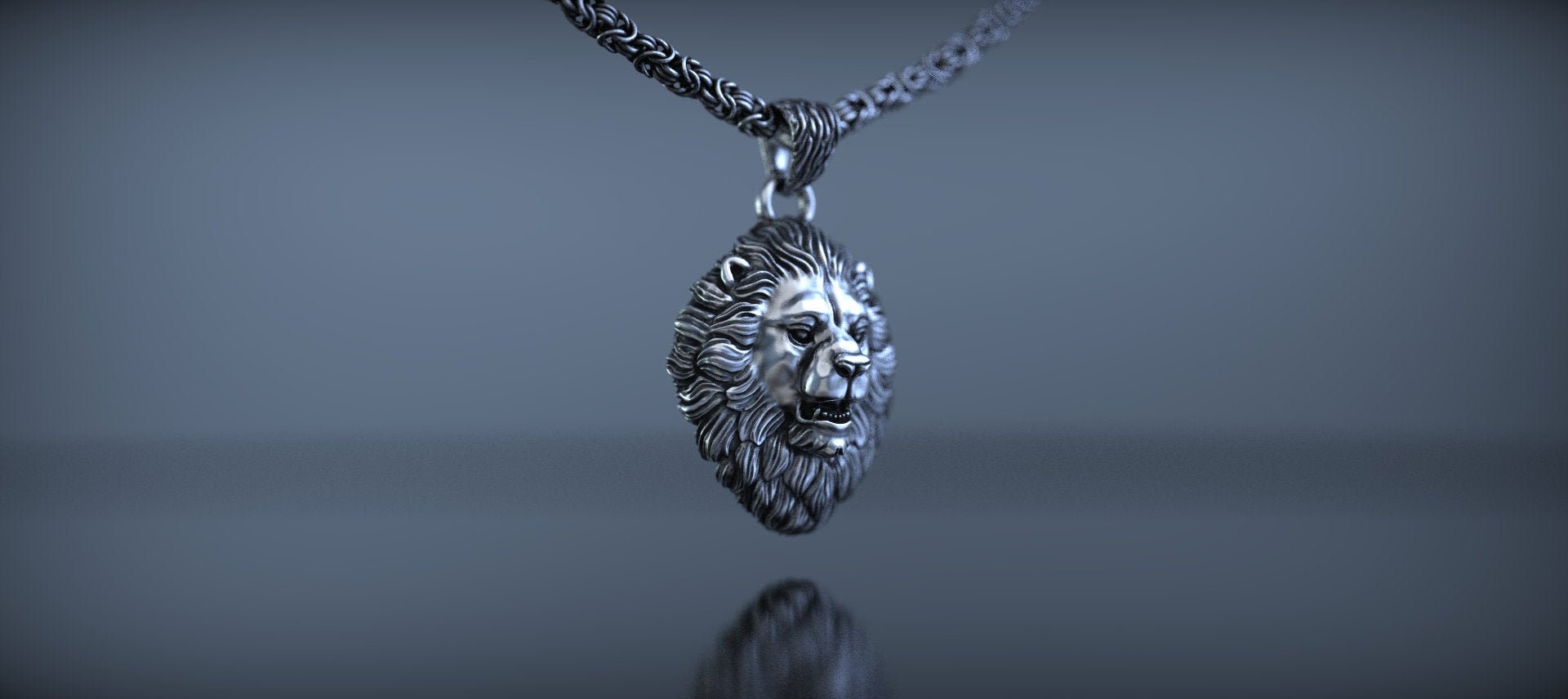 Side view of handmade silver lion pendant