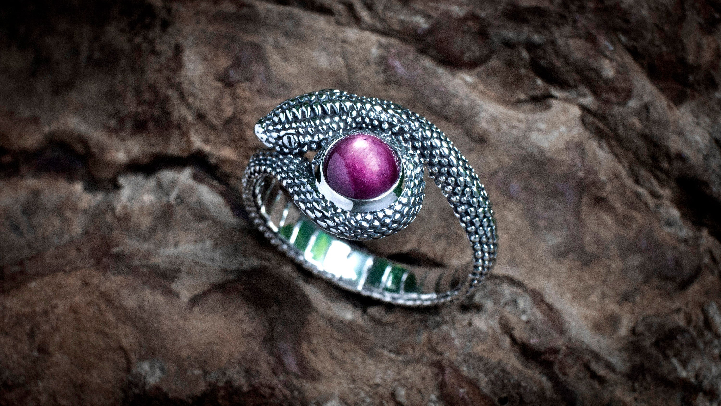 Handmade silver serpent ring shown from angled profile
