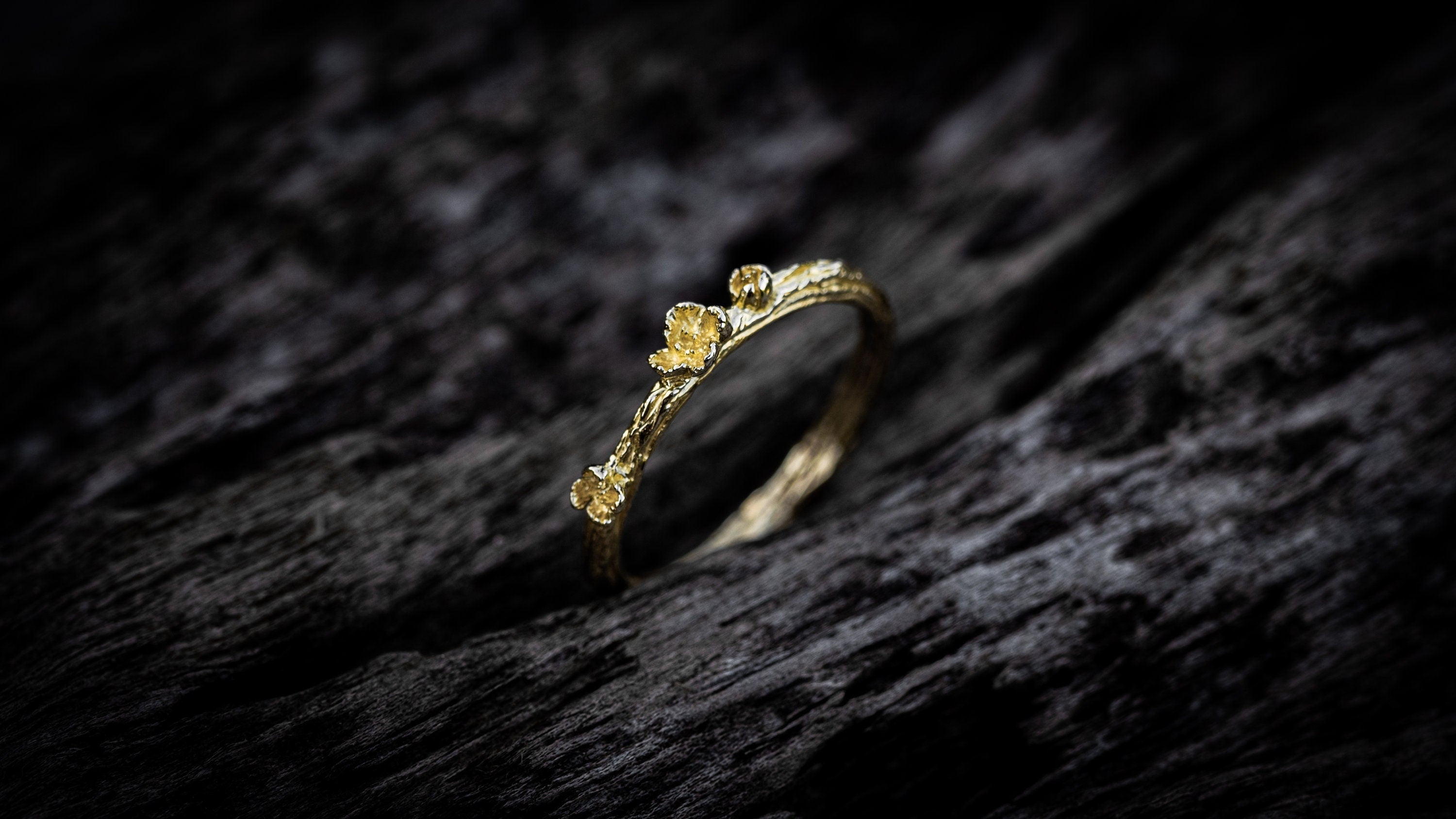 Nature-inspired gold wedding bands displayed together