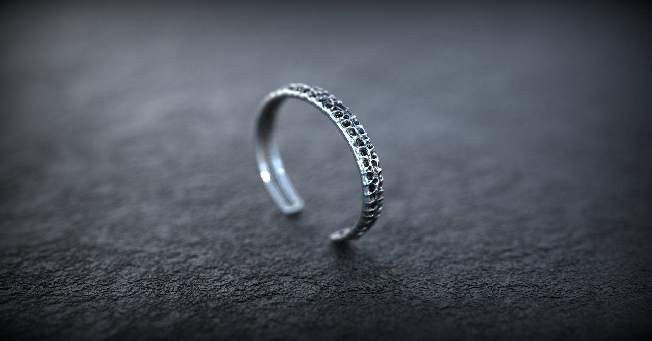 Handmade silver bangle bracelet with textured details