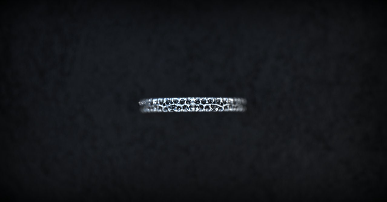 Silver cuff bracelet with sculptural carved pattern