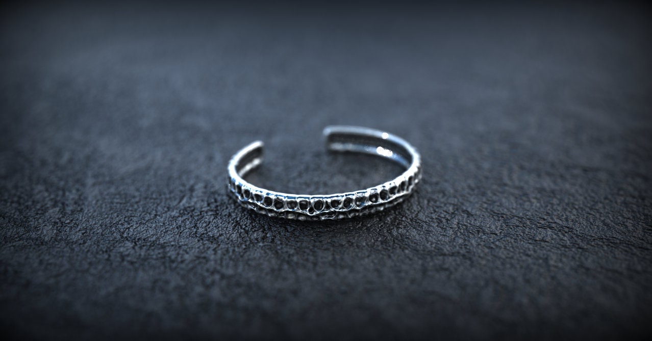 Sterling silver carved cuff bracelet shown from alternate angle